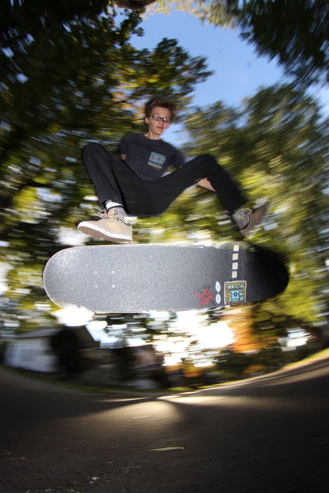 A skateboarder does a kickflip.